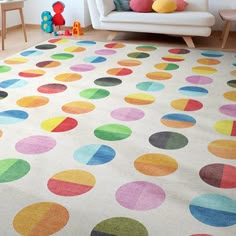 a living room with a white couch and multicolored rugs on the floor