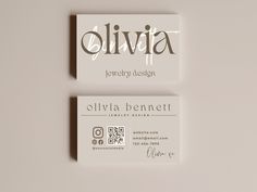 two business cards sitting side by side on top of a white surface, with the name ollivia written in cursive