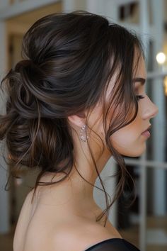 a woman with her hair in a low bun