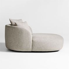 a white couch with two pillows on it's back and the seat upholstered