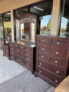 a large wooden dresser sitting in front of a store