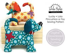 a toy dog sitting on top of a wooden block with the words lucky and lola pincush or toy sewing pattern below it