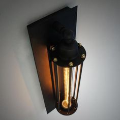 an old fashioned light fixture on the wall