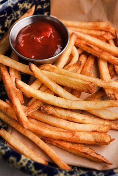 french fries with ketchup on a blue and white plate