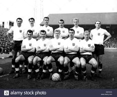 the england team line up for a group photo in front of an old stadium