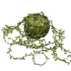 a ball of green string with leaves on it's side and one strand attached to the end