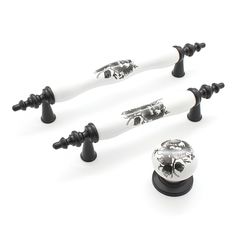 four black and white knobs with skulls on them are set against a white background