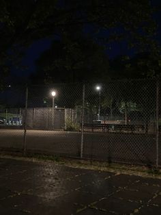 an empty parking lot at night with lights on