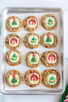 cookies decorated with icing and christmas trees on a cookie sheet