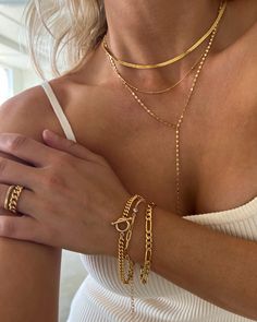 "This thin 3mm herringbone gold necklace is what layering necklaces is all about. Made in 14k gold filled, this chain will not tarnish. This bold gold chain will pair nicely with daintier chains, long and short, or make a statement all on its own. Dimensions 3\" thickness and 16\", 18\" and 18\" + 2\" extension Materials 14k gold filled *Hypoallergenic *Nickel free *Tarnish resistant *Water resistant *Handmade in USA Notes ~ Soft jewelry pouch included.  ~ Limit contact with water for longer durability and prevent tarnishing ~ Avoid contact with household chemicals like perfume, sprays, lotions, sunscreen and hair products.  ~ Store your jewelry separately from other jewelry when not in use. Secure clasps and closures to avoid scratches and tangled chains. Ideally, we recommend to keep you Dainty Gold-tone Figaro Chain Jewelry, Dainty Tarnish Resistant Snake Chain Necklace, Dainty Tarnish-resistant Snake Chain Necklace, Dainty Snake Chain Necklace For Layering, Gold Plated Figaro Chain Choker, Gold-plated Figaro Chain Choker, Dainty Gold Chain Choker Jewelry, Minimalist Figaro Chain Choker, Minimalist Figaro Chain Choker Jewelry