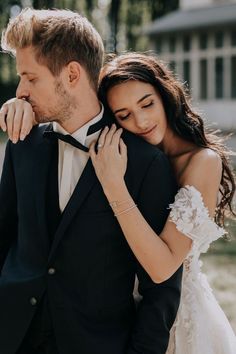 a man in a tuxedo and woman in a wedding dress are embracing each other