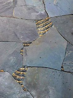 a stone walkway with yellow and black beads on it