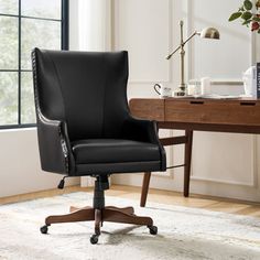 a black leather office chair sitting in front of a desk with a book on it