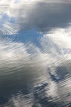 the ripples in the water are reflecting the sky