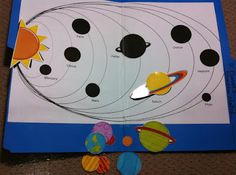 an open book with pictures of solar system on the pages and cut out parts to make it