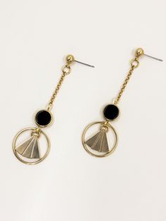 These earrings are inspired by the geometric patterns characteristic of the Art Deco era. Polished, semi precious black agate stone feature at the centre, contrasting with the surrounding warm, golden brass.  The bold lines and symmetry of the design are simultaneously classic and contemporary.  Held by a solid brass stud with stainless steel earring post.  Approximate measurements- 6.5cms long 2cms wide  ✨All Set Theory jewellery comes with care instructions and a polishing pad to keep your jewels looking shiny and fabulous! Modern Black Circular Jewelry, Black Geometric Jewelry, Modern Gold Earrings With Black Enamel, Black Circular Metal Jewelry, Single Black Brass Earring, Gold Minimalist Earrings With Black Enamel, Modern Gold Onyx Earrings, Minimalist Black Brass Jewelry, Set Theory