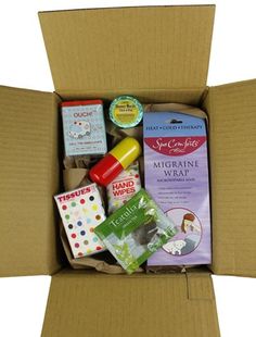 an open cardboard box filled with baby items including diapers, wipes and more