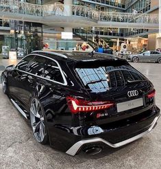 an audi car parked in front of a building