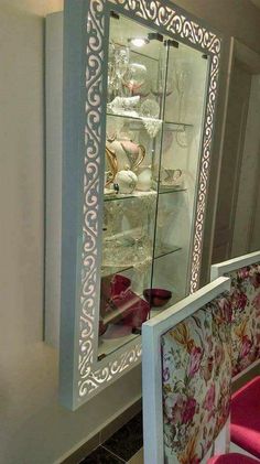 a display case with glass doors and flowers on it