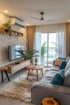 a living room filled with furniture and a flat screen tv on top of a wooden stand