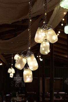 an instagramted photo of mason jars hanging from a chandelier