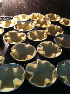 many bowls are lined up in rows on the stove top and ready to be cooked