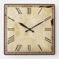 a square clock with roman numerals is shown in brown and beige tones,