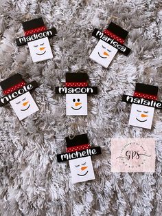 snowman name tags are hanging on the carpet