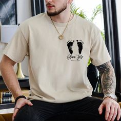 a man wearing a t - shirt with two footprints on it