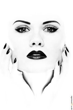 a woman's face with black and white makeup