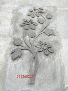 a decorative flower design on the side of a wall