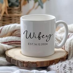 a white coffee mug sitting on top of a wooden table