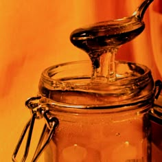 a glass jar with a spoon sticking out of it