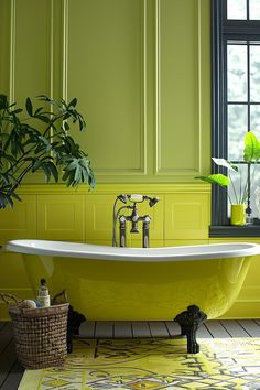 a bathroom with green walls and yellow bathtub