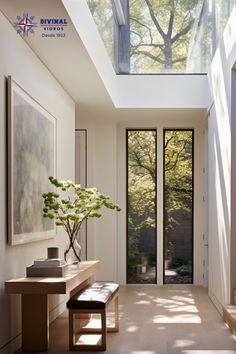 a room with a bench, table and large glass window on the ceiling above it