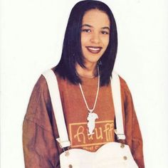 a young woman is smiling and holding an apron in her hands while standing against a white background