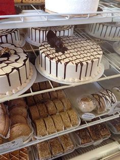 several cakes and pastries on display in a bakery