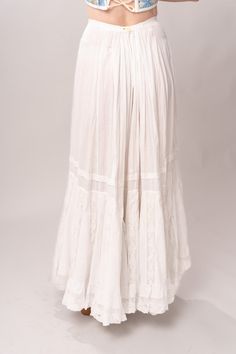 Stunning Edwardian 1910’s white cotton and lace maxi petticoat skirt. With a pretty flare silhouette, panel lace detail, and a button closure at waist. Good vintage condition, with normal wear and condition for its age. Some areas of visible mending a minor staining - see pictures. Best fits modern size XS/S Waist 26”Length 42” Featured top is the Blue Doll Quilt Corset from our friends at Psychic Outlaw. Model’s Measurements:Height 5’9”Chest 34”Waist 29”Hips 36.5” Vintage White Gathered Skirt Bottoms, Daywear Long Lace Skirt, Bohemian Long Skirt For Daywear, White Lace Vintage Bottoms, Vintage White Lace Bottoms, White Vintage Lace Bottoms, Vintage White Bottoms For Wedding, Lace Trim Maxi Skirt For Wedding, Flowy Wedding Maxi Skirt With Lace Trim