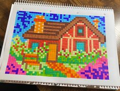 a drawing of a house made out of legos on top of a wooden table