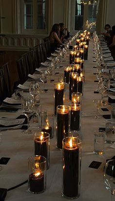 a long table with many lit candles on it