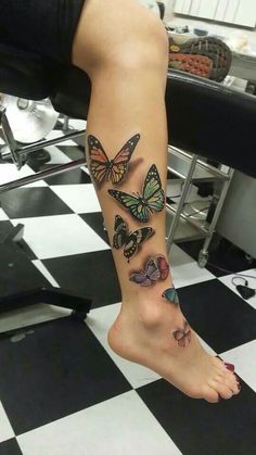 a woman's foot with butterflies on it and a black and white checkered floor