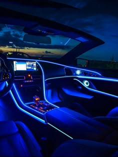 the interior of a car is lit up with blue lights