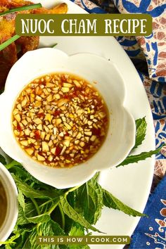 there is a bowl of soup with nuts in it on the plate next to other dishes