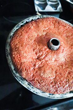 a round cake sitting on top of a stove