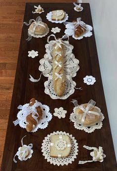 breads and pastries laid out on a table with lace doily around them