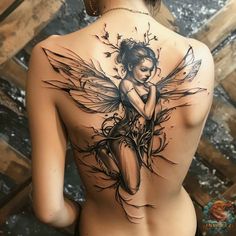 a woman's back with a tattoo design on her shoulder and the image of a fairy