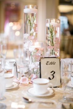 the table is set with flowers and candles