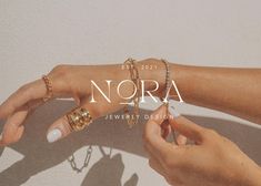 two hands holding onto each other with the word nora on it in front of them