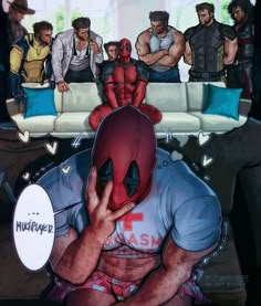 a man in a deadpool shirt is covering his face