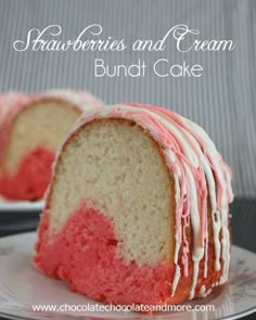 a bundt cake with pink and white frosting on top is cut in half